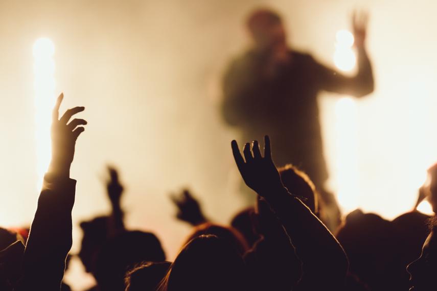 dancing-concert-while-singer-is-performing-surrounded-with-lights