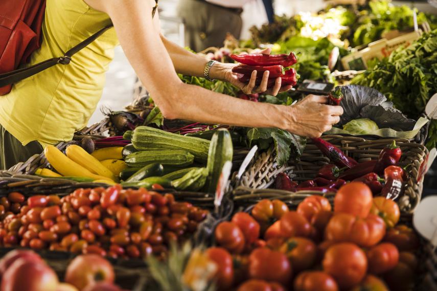 man-choosing-vegetable-from-vegetable-stall-supermarket