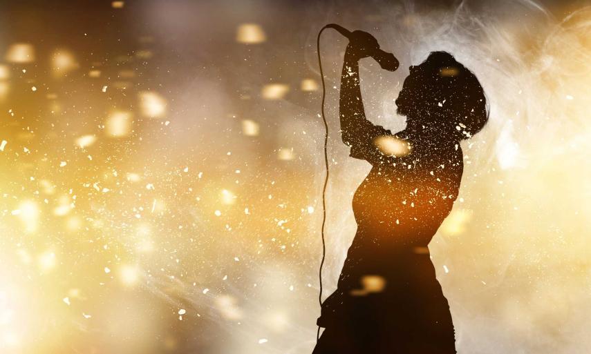 singer-holding-microphone-abstract-background